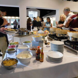 people going through food line at event