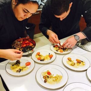 Professional personal chefs preparing plates for a special event.
