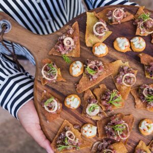 an image of someone holding a platter of appetizers